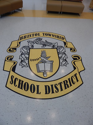 school logo/crest on hallway floor
