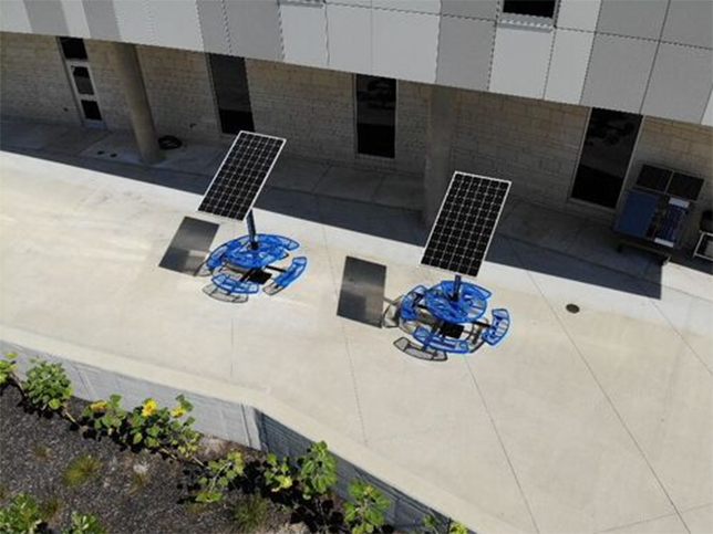 Over the summer, Olathe West High School added solar panels over two picnic tables where students can charge their phones and laptops. 