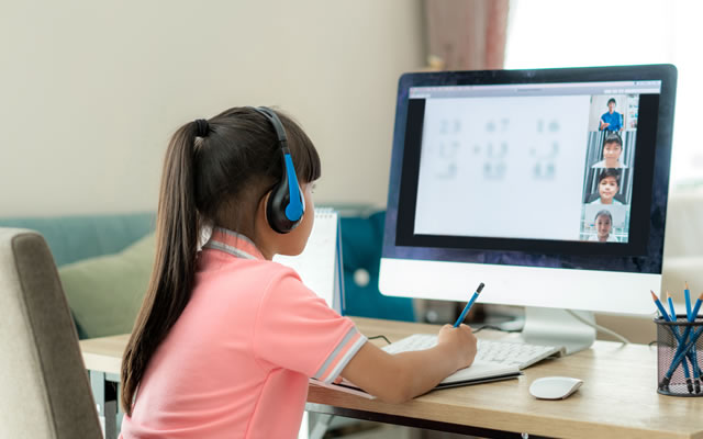young girl attending class on her computer