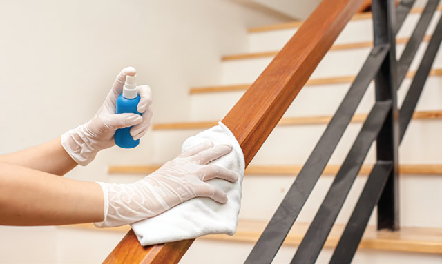 cleaning hand rails on staircase